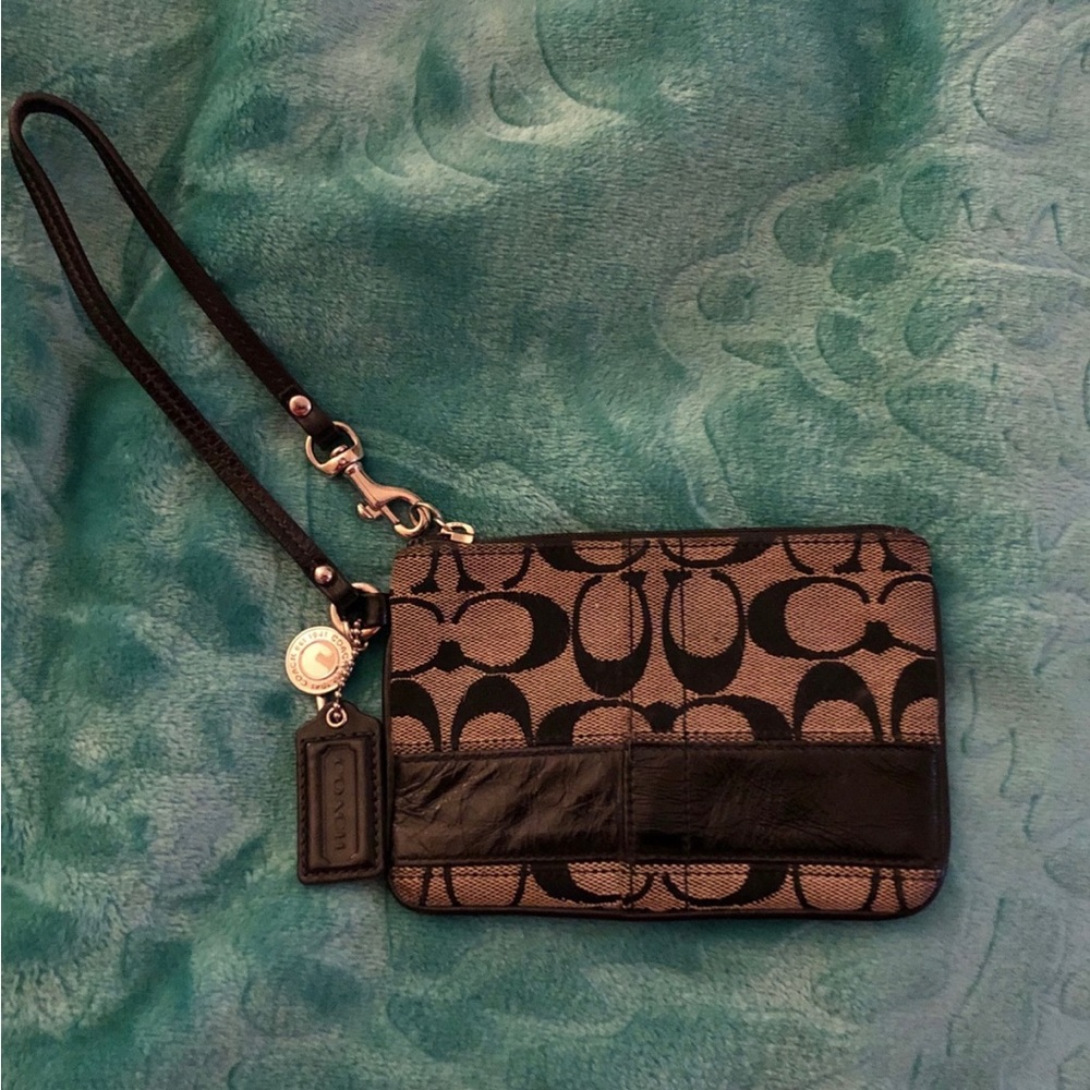 A really nice women’s coach purse or clutch. Black and dark gray in color. ￼￼
